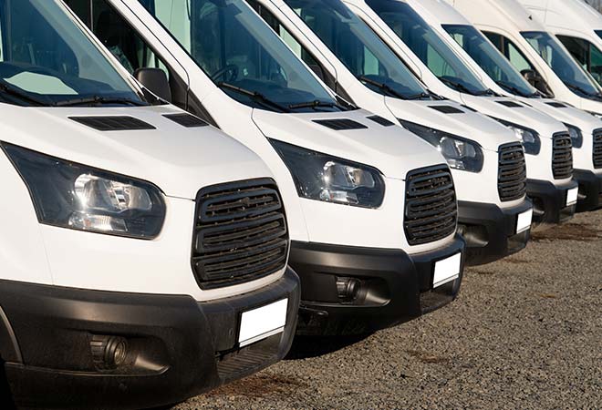 A fleet of cars side by side in a parking lot.