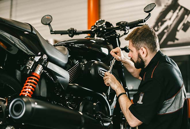 Man repairing a motorcycle.