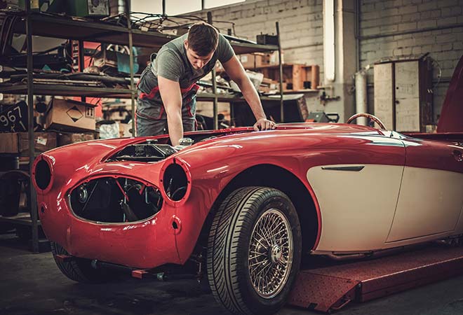 Classic red car being worked on and restored.